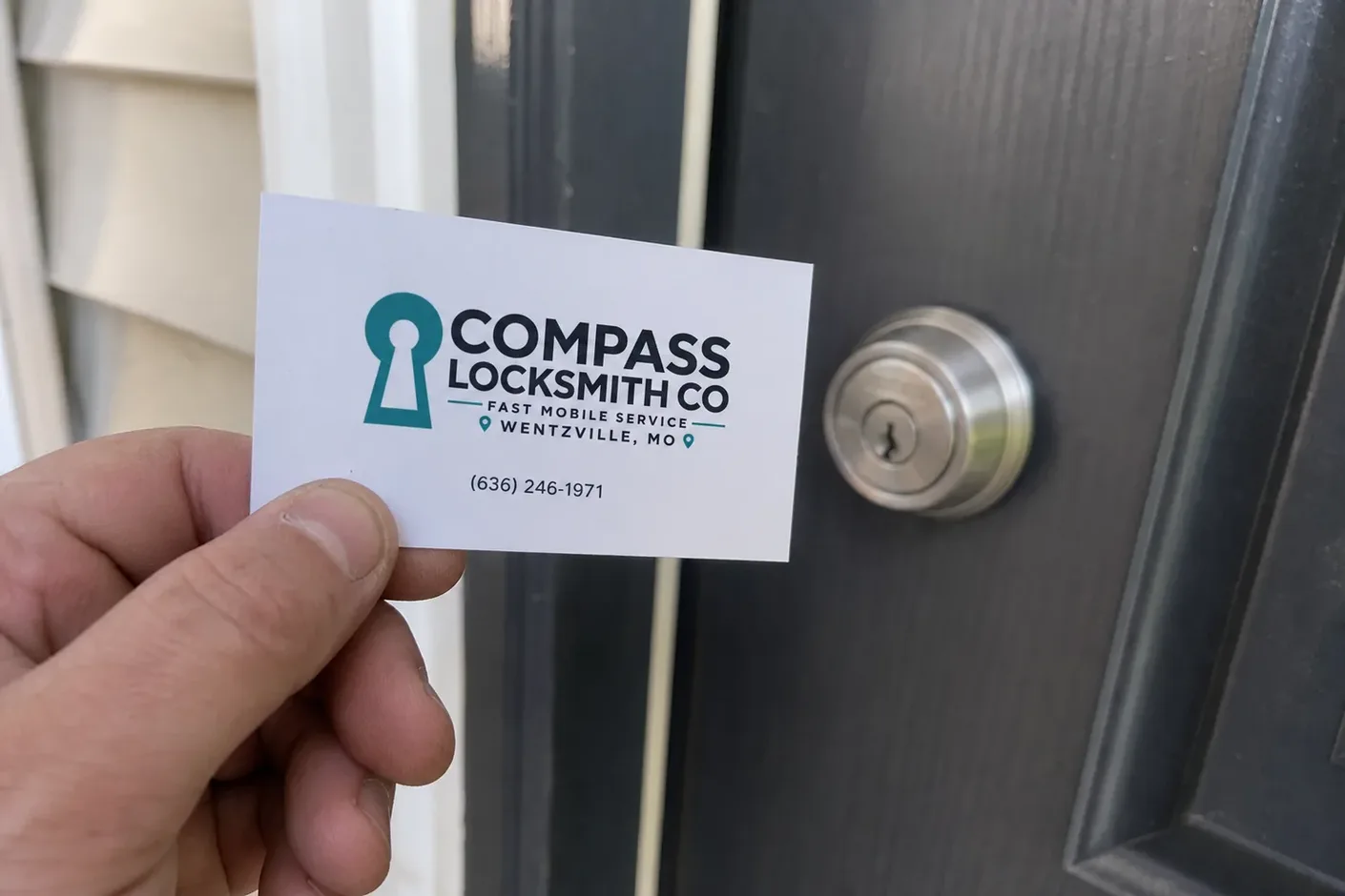 Compass Locksmith Co business card left at a job in Wentzville, MO
